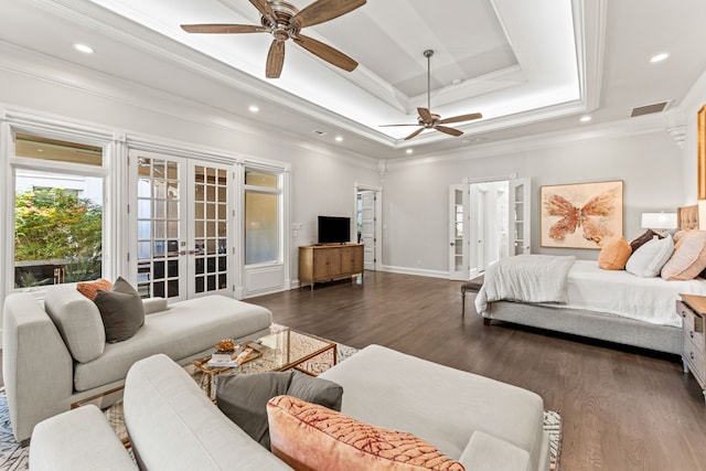 bedroom featuring ceiling fan, dark wood-type flooring, a raised ceiling, and french doors