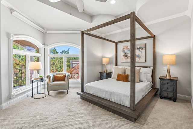 bedroom featuring ceiling fan, light colored carpet, and multiple windows