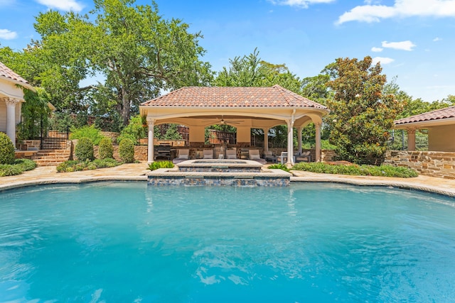 view of pool featuring an in ground hot tub and a gazebo