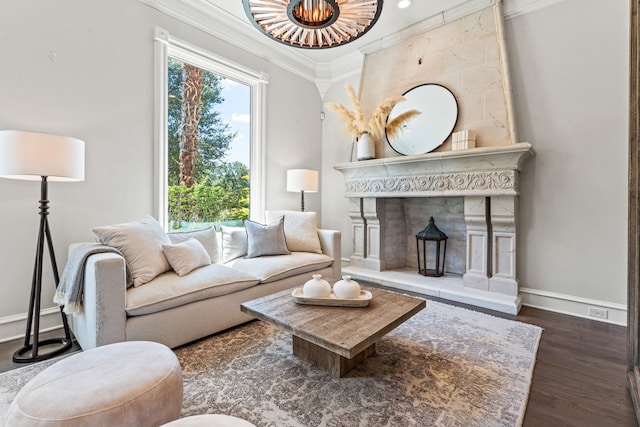 living room featuring crown molding, a tile fireplace, and dark hardwood / wood-style flooring