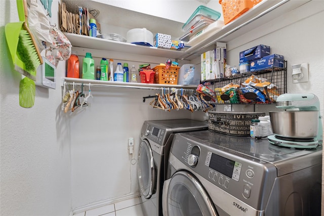 laundry room with separate washer and dryer, laundry area, and tile patterned flooring