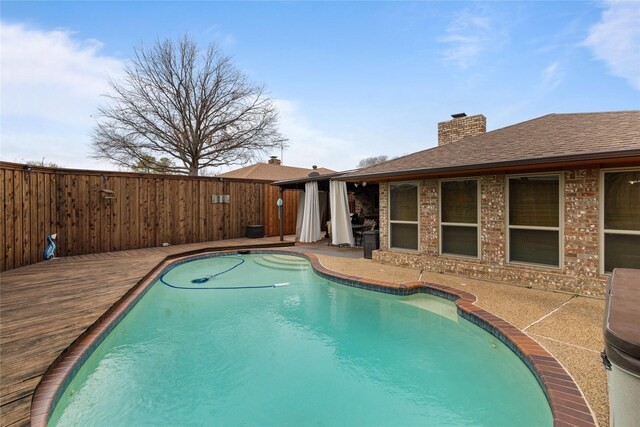 view of pool featuring a fenced in pool, a fenced backyard, and a patio area