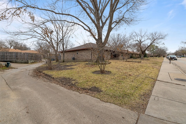 exterior space with brick siding and fence