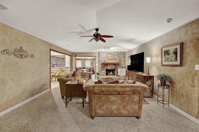 living room with baseboards, carpet floors, ceiling fan, and a fireplace