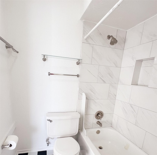 bathroom featuring tiled shower / bath combo and toilet