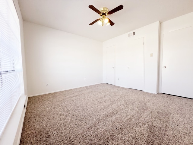 unfurnished bedroom with carpet floors and ceiling fan