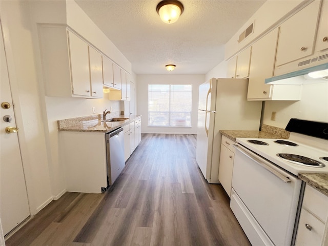 kitchen featuring dark wood-type flooring, white appliances, a textured ceiling, and white cabinets