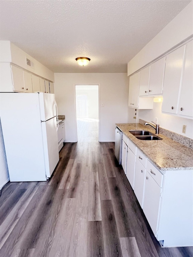 kitchen with dishwasher, sink, white cabinets, dark hardwood / wood-style flooring, and white fridge