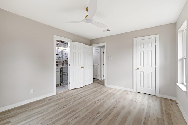 unfurnished bedroom featuring ceiling fan, ensuite bathroom, light hardwood / wood-style flooring, and a closet