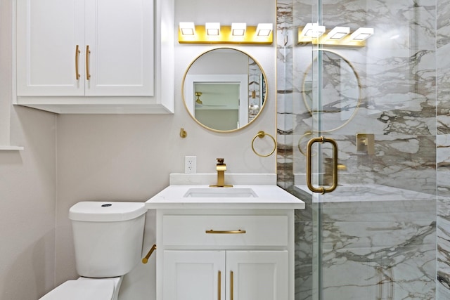 bathroom with an enclosed shower, vanity, and toilet