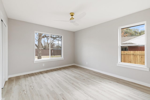 empty room featuring ceiling fan and light hardwood / wood-style flooring