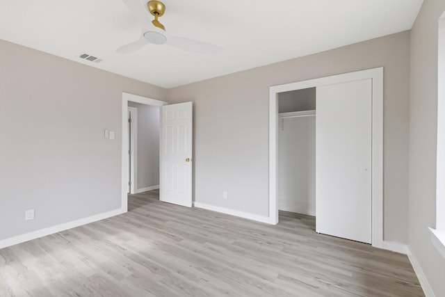 unfurnished bedroom featuring ceiling fan, light hardwood / wood-style floors, and a closet