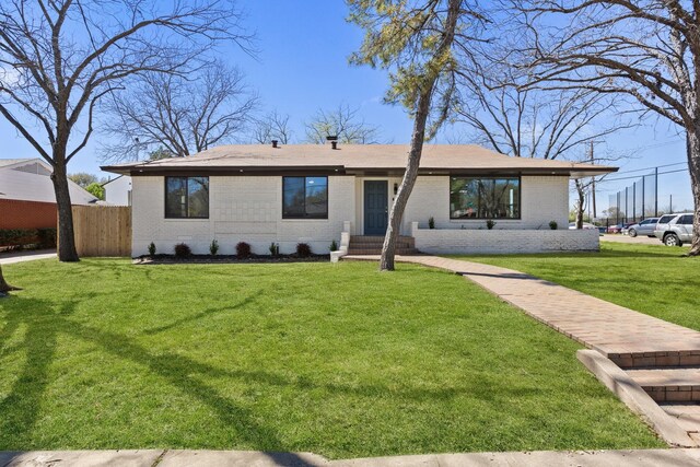 ranch-style home featuring a front yard