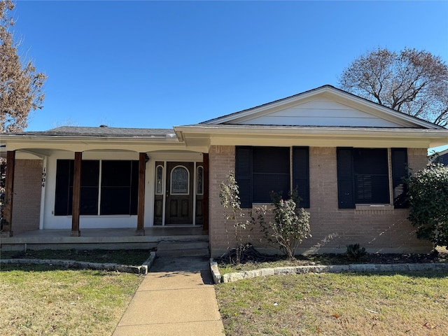 view of front of house with a front yard and a porch