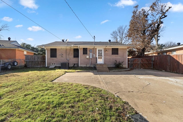 rear view of property featuring a yard and central air condition unit