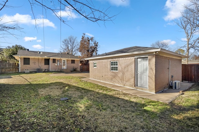 back of house featuring a patio, central AC unit, and a lawn