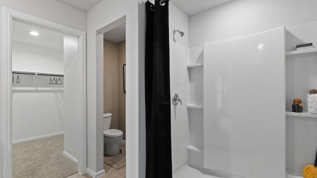 bathroom featuring toilet and a shower