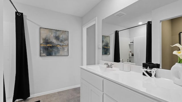 bathroom with tile patterned floors and vanity