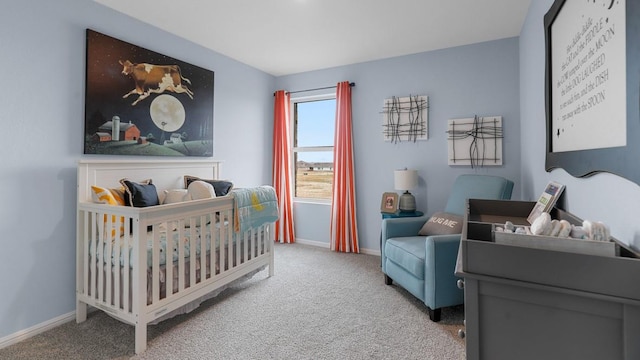 carpeted bedroom with a nursery area