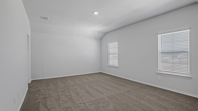 empty room with carpet and lofted ceiling