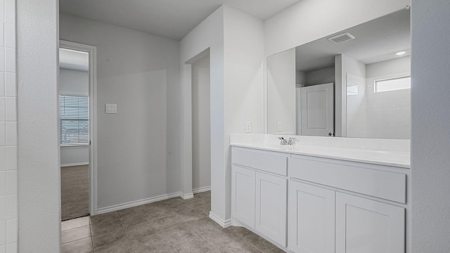 bathroom featuring plenty of natural light, tile patterned floors, and vanity