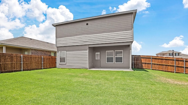 rear view of property featuring a patio area and a lawn