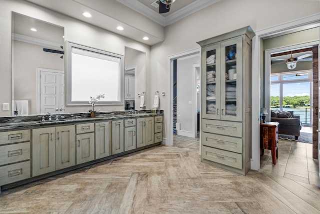 bathroom with vanity, ceiling fan, ornamental molding, and parquet flooring