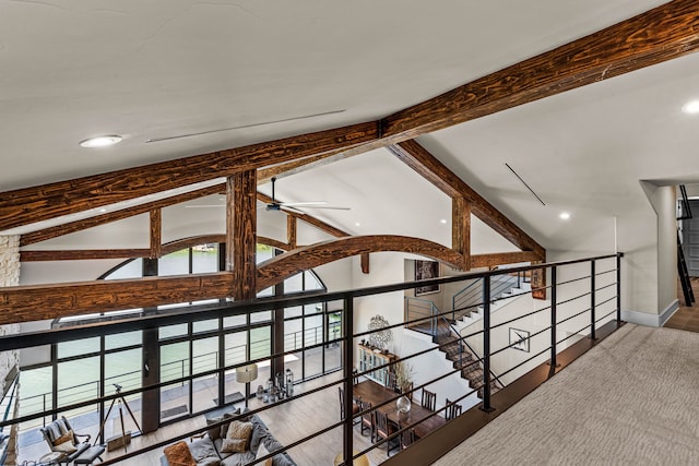 hall with hardwood / wood-style flooring and vaulted ceiling with beams