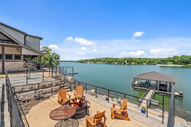 exterior space featuring an outdoor fire pit and a dock