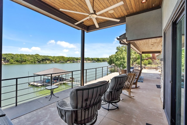 view of patio / terrace featuring ceiling fan, a balcony, and a water view