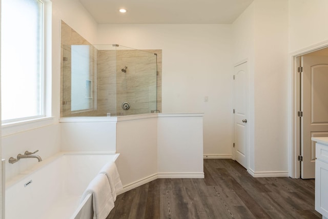 bathroom with independent shower and bath, vanity, and wood-type flooring