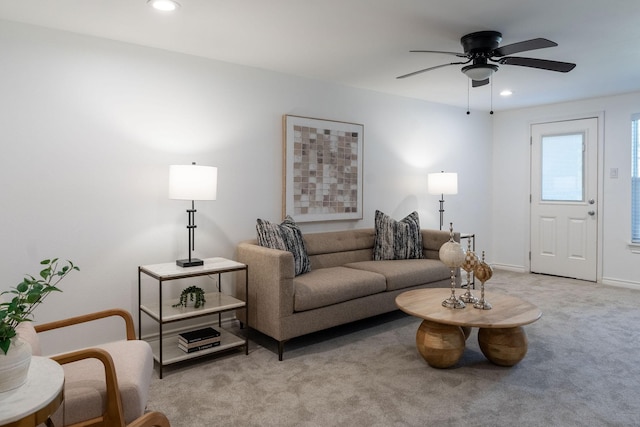 living room featuring light colored carpet and ceiling fan