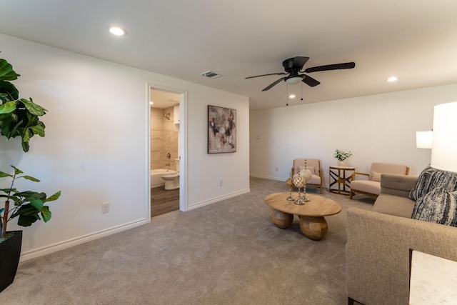 carpeted living room featuring ceiling fan