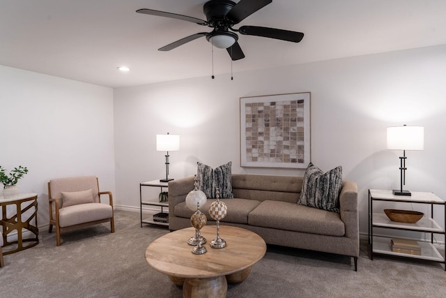 carpeted living room with ceiling fan