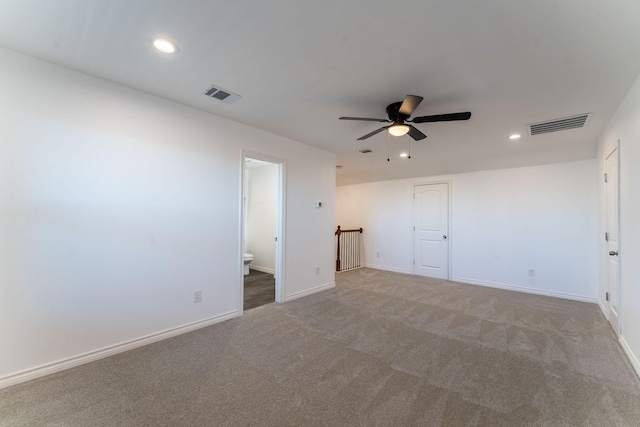 carpeted empty room featuring ceiling fan