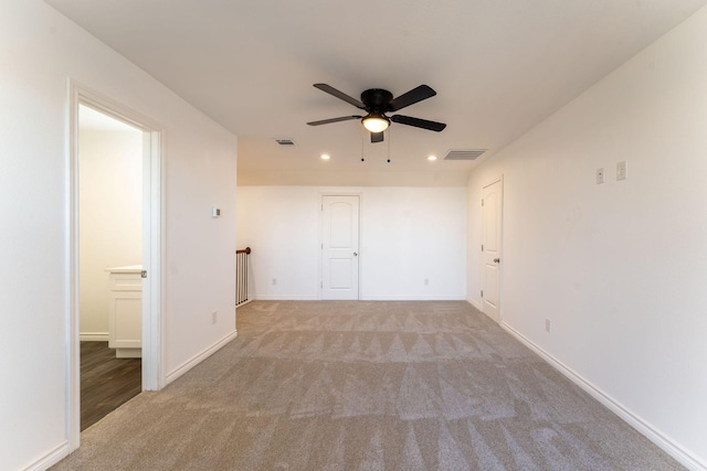 spare room featuring ceiling fan and light colored carpet