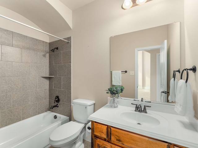 full bathroom with tiled shower / bath combo, vanity, and toilet