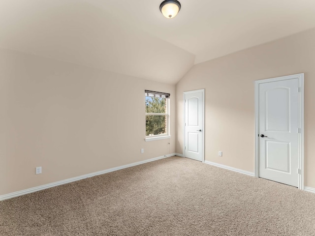 interior space featuring lofted ceiling and carpet flooring