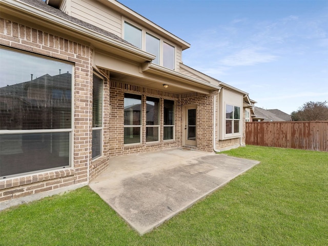 back of house with a yard and a patio area