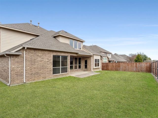 back of property with a yard and a patio area