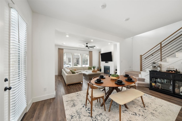 dining area with ceiling fan and dark hardwood / wood-style floors