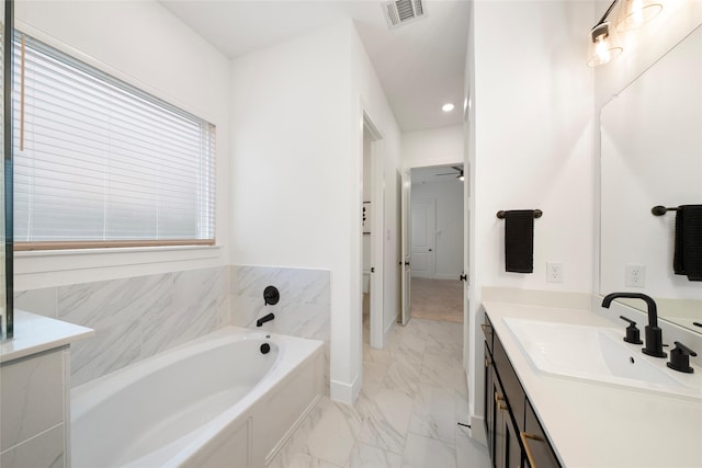 bathroom with vanity and a washtub