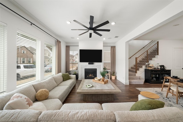 living room with ceiling fan, dark hardwood / wood-style floors, and a fireplace