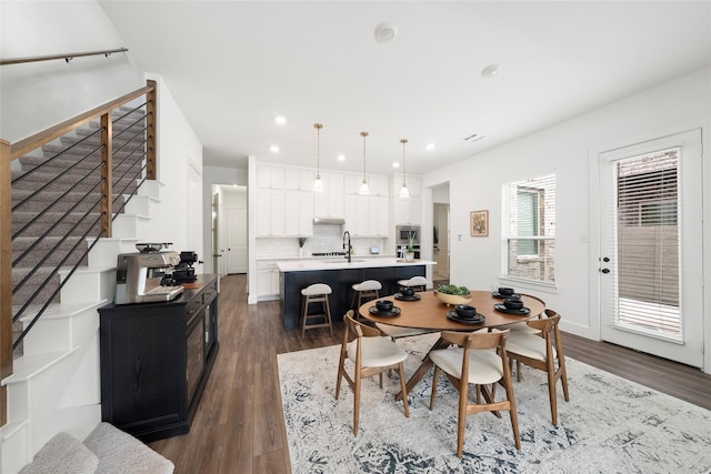 dining space with sink and dark hardwood / wood-style flooring