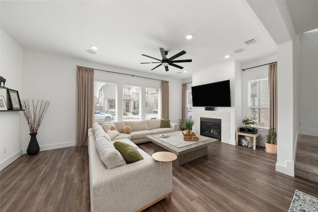 living room with ceiling fan, dark hardwood / wood-style floors, and a fireplace