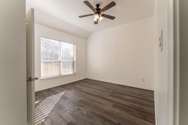 unfurnished room with dark hardwood / wood-style floors, vaulted ceiling, and ceiling fan