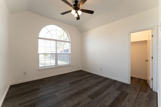 unfurnished room with ceiling fan, dark hardwood / wood-style floors, and lofted ceiling