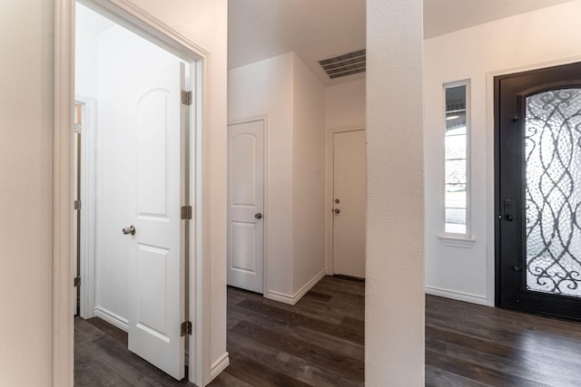 foyer entrance with dark hardwood / wood-style floors