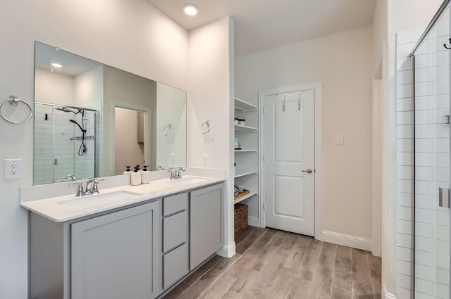 bathroom with walk in shower and vanity