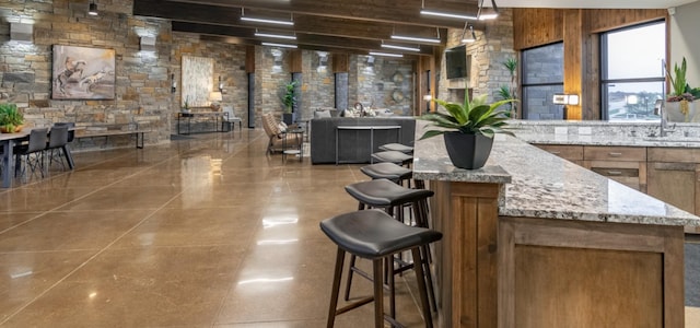 interior space with wooden walls and light stone countertops